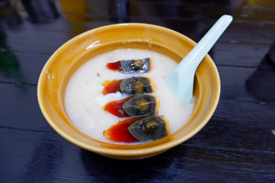 A bowl of congee with century eggs.